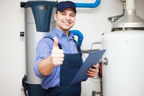 Smiling technician servicing a hot-water heater